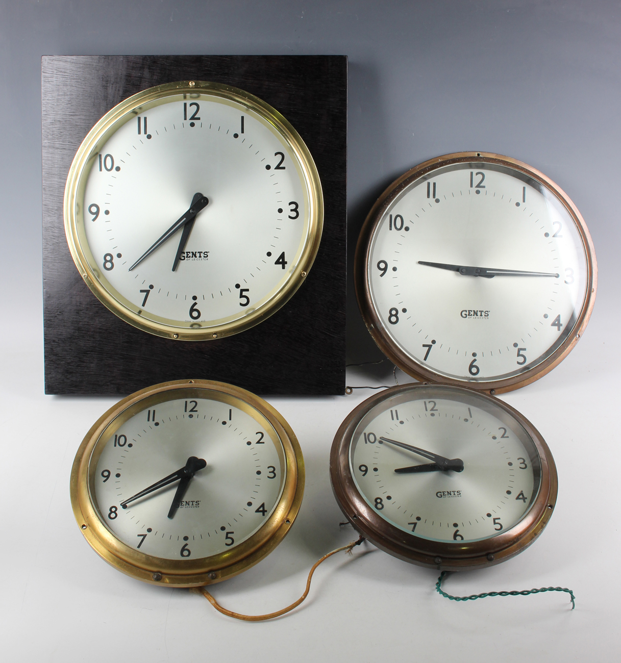 Two Gents of Leicester brass cased circular electric slave wall clocks, each 7½-inch signed silvered