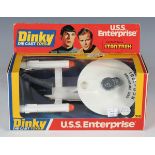 A Dinky Toys No. 358 USS Enterprise with sealed photon torpedoes, within a window box (box lightly