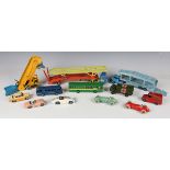 A collection of playworn Dinky Toys and Supertoys vehicles, including No. 300 Massey-Harris tractor,