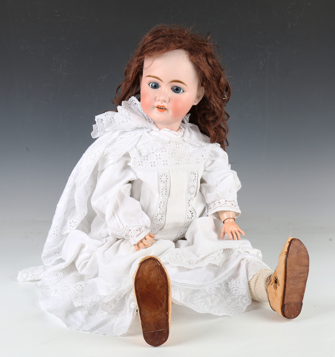 A Pierre Muller Olympia bisque head doll with brown wig, card pate, sleeping eyes, pierced ears,