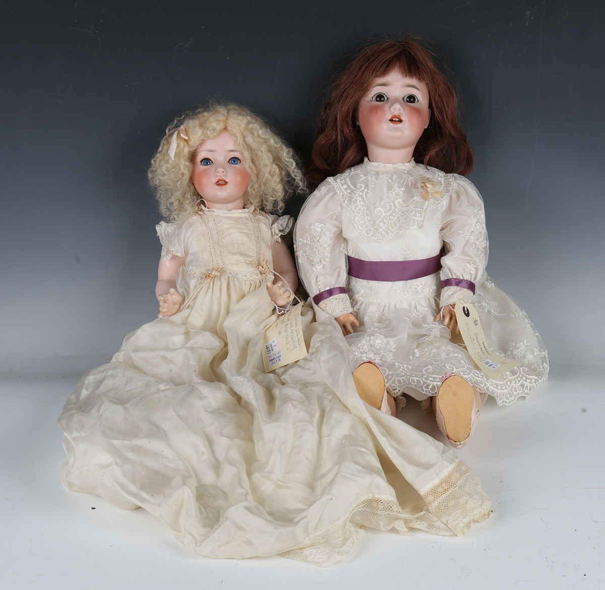 A Schoenau & Hoffmeister bisque head doll, impressed '1909 7½', with later brown wig, sleeping brown