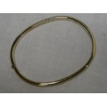 A 9ct plain gold oval bangle