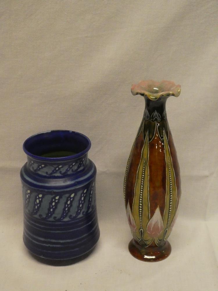A Royal Doulton pottery Art Nouveau-style tapered spill vase with raised floral decoration on blue