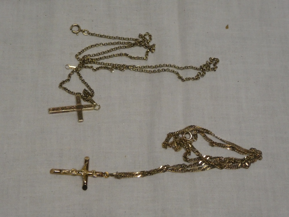 Two various 9ct gold crucifix pendants with 9ct gold chains
