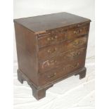 A small George III mahogany chest of drawers with a brushing slide above two short and three long