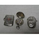 An Edward VII silver circular sovereign case with engraved decoration,