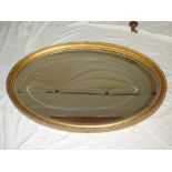 A good quality bevelled oval wall mirror in gilt frame 38" long