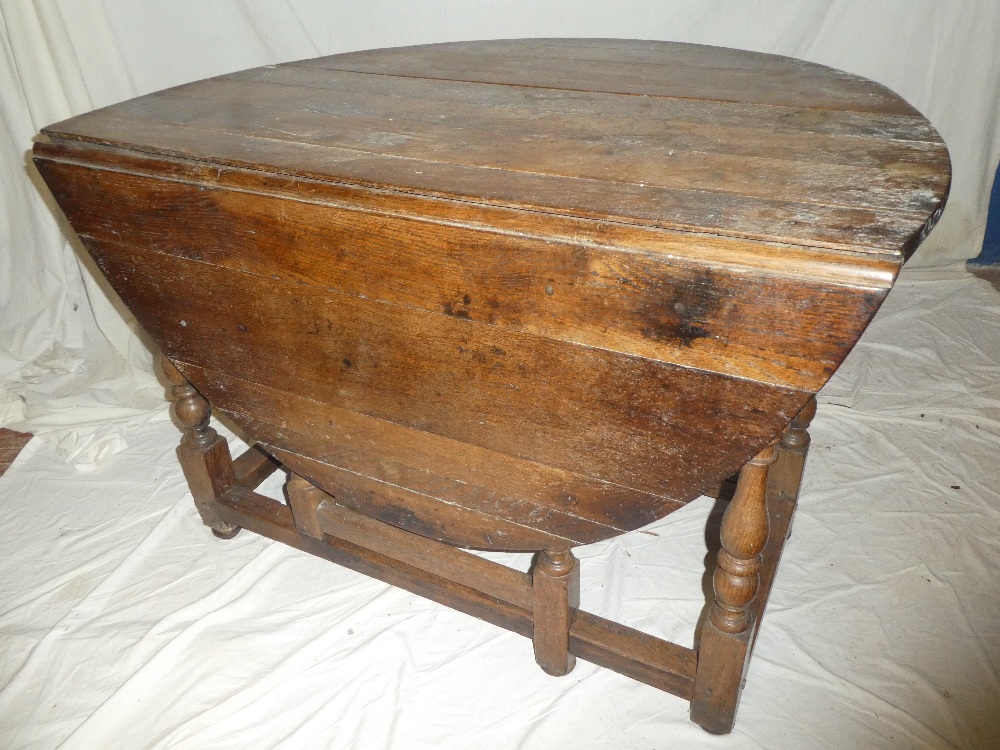 A Charles II and later oak oval gate leg dining table with a drawer in each end on baluster tapered - Image 2 of 2