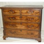 An early 19th century mahogany chest of two short and three long drawers with brass ring handles,
