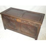A late 18th/early 19th Century carved oak rectangular coffer with double panelled front and hinged
