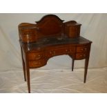 A late Victorian inlaid mahogany ladies writing desk with a single curved frieze drawer flanked by