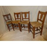 A set of four 19th century Continential elm dining chairs with vase splat backs and rushwork seats
