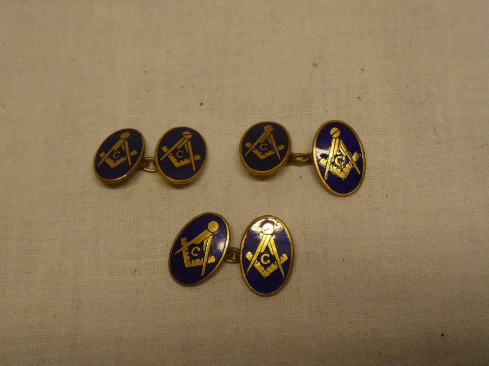 Three matching gilt and enamelled oval Masonic cufflinks