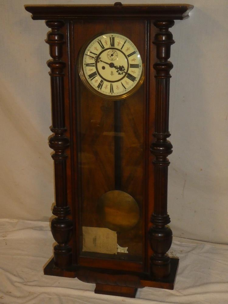 A good quality Vienna regulator wall clock with decorated circular dial in polished mahogany