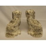 A pair of Victorian Staffordshire pottery figures of seated spaniels,