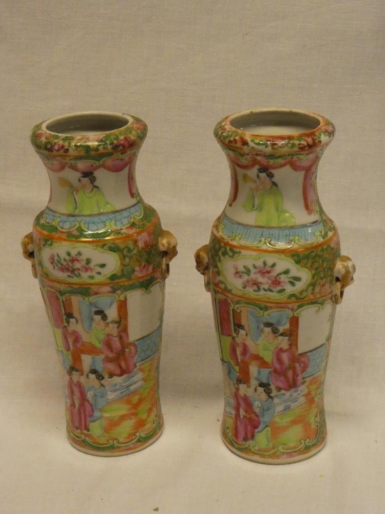 A pair of Cantonese china tapered vases with painted figure and floral decoration 8" high (slight