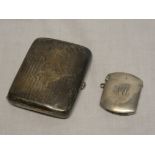 A silver rectanglar concave cigarette case with engraved initials,