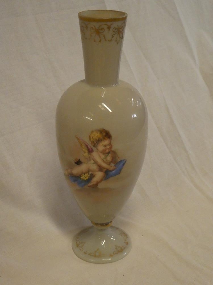 A 19th Century opaque glass tapered pedestal vase decorated with a cherub figure within gilt