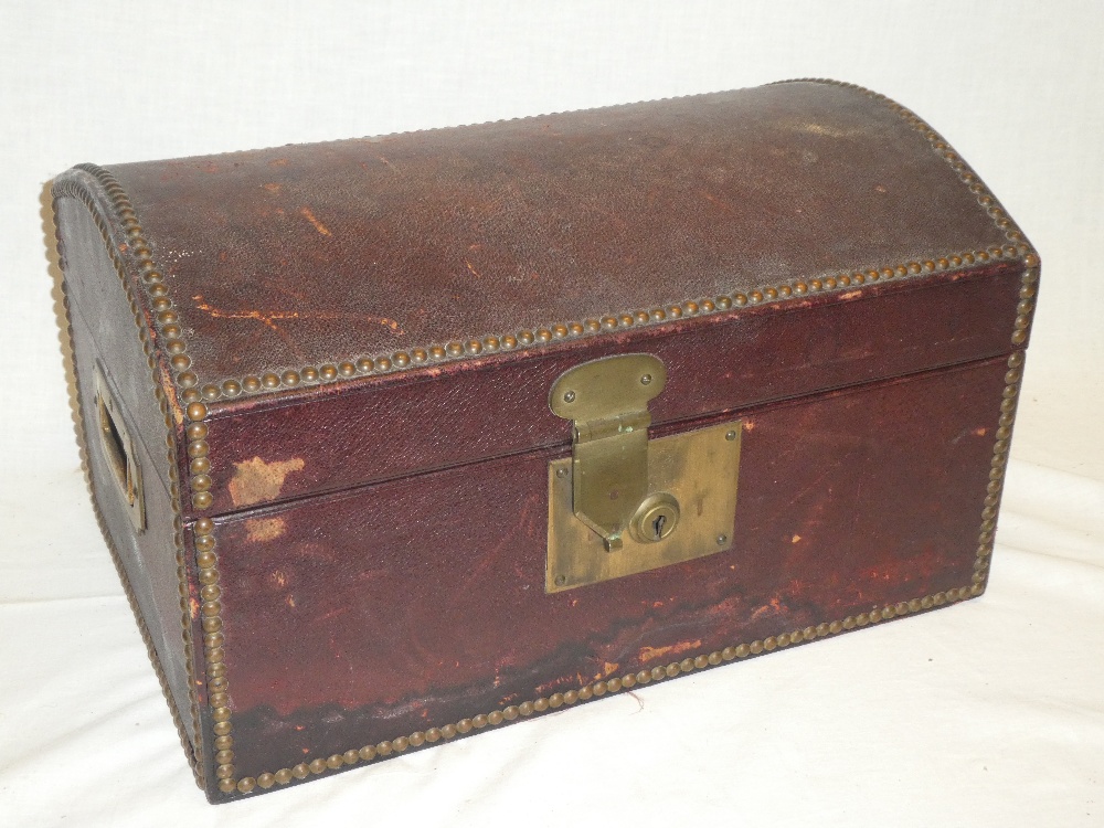 A good quality brass mounted Morocco leather domed travelling box with inset handles and hinged lid
