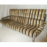 A 1970's chromium plated three-seat settee by Pieff with brown and black striped nylon upholstery