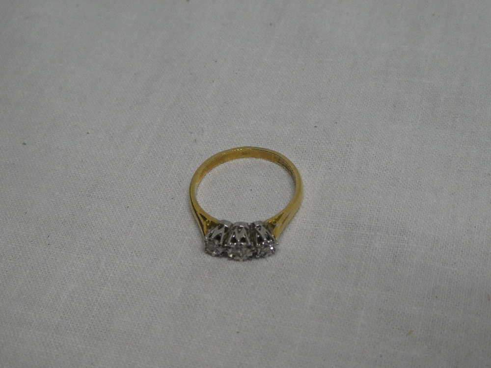 An 18ct gold engagement ring set three diamonds