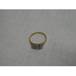 An 18ct gold engagement ring set three diamonds