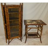 An old bamboo and lacquered corner cabinet with shelves enclosed by a single glazed door and one