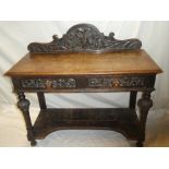 A late Victorian carved oak rectangular side table with two drawers in the frieze on turned