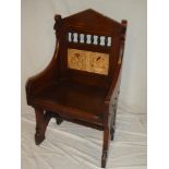 A Victorian walnut hall chair by Johnson & Appleyard with inset ceramic tiled back and polished
