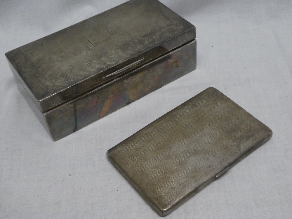 A George VI silver rectangular cigarette box with hinged lid,