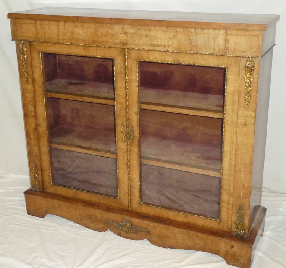 A 19th century inlaid walnut display cabinet with fabric lined shelves enclosed by two glazed doors