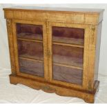 A 19th century inlaid walnut display cabinet with fabric lined shelves enclosed by two glazed doors
