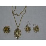 An unusual jewellery set comprising 12ct gold scroll pendant set smoky quartz with attached 18ct