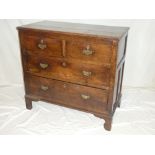 An 18th century oak chest of two short and two long drawers with brass ring handles on bracket feet