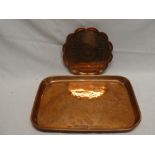 A polished copper rectangular tray and one other copper circular tray with incised decoration (2)