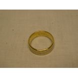 A broad 18ct gold wedding band with inset platinum centre