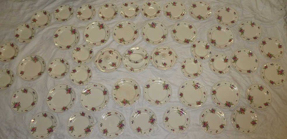 A Bristol pottery part dinner set with floral decorated borders comprising a pair of circular two