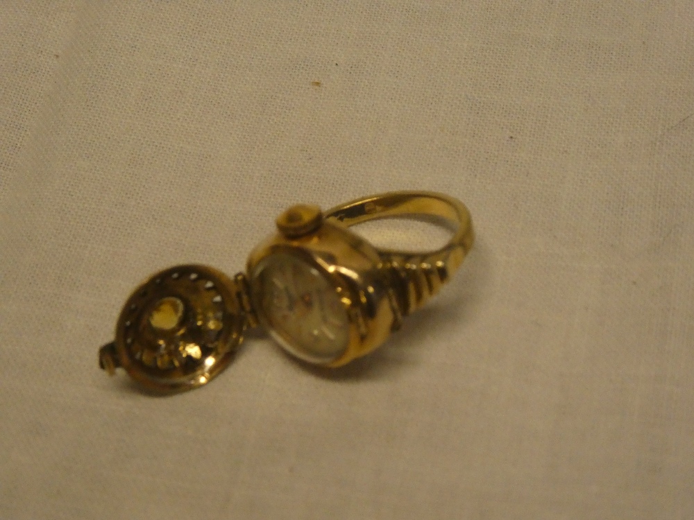 A lady's gold-plated dress ring with mount opening to reveal a miniature watch by Bessa