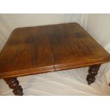 A Victorian mahogany rectangular extending dining table on bulbous turned tapered legs with brass