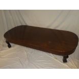 A large figured mahogany shaped-rectangular coffee table on cabriole legs with claw and ball feet,