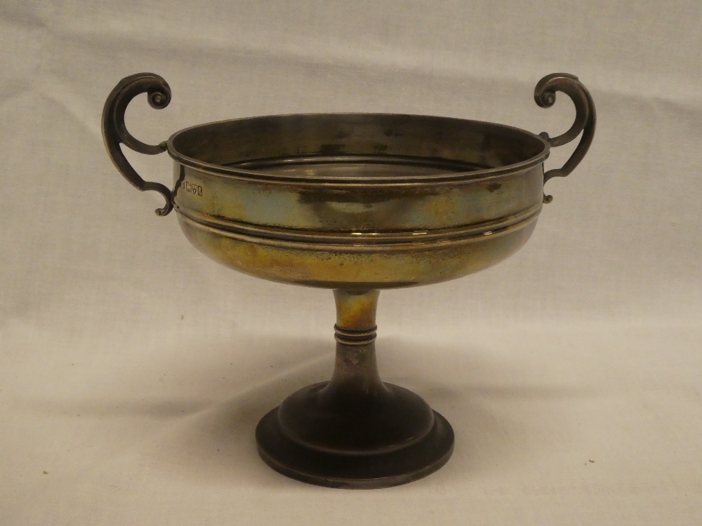 An Edward VII silver two handled circular pedestal bowl with scroll handles, Chester marks 1905,