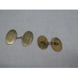 A pair of gentleman's 9ct gold oval cufflinks with engine turned decoration