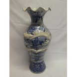 A 19th Century Japanese pottery baluster-shaped vase with raised dragon decoration on blue and