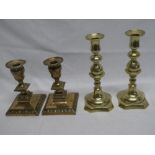 A pair of 19th century copper tapered candlesticks with raised decoration on square bases 6½" high