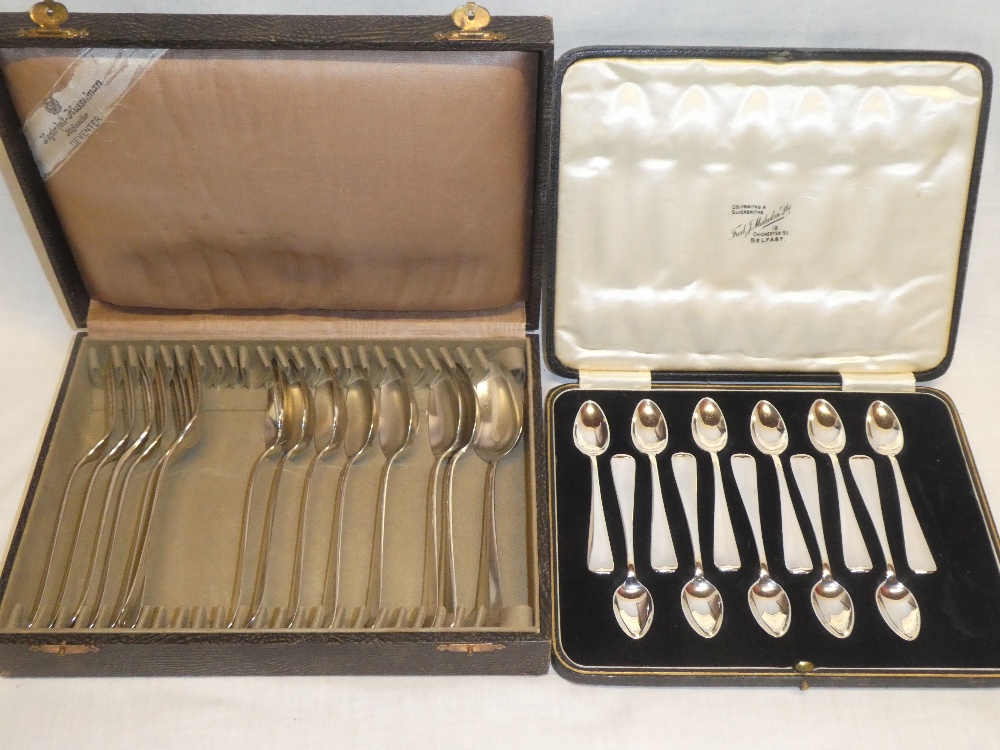 A part set of eight French silver dessert spoons and seven matching forks in lined case and a part