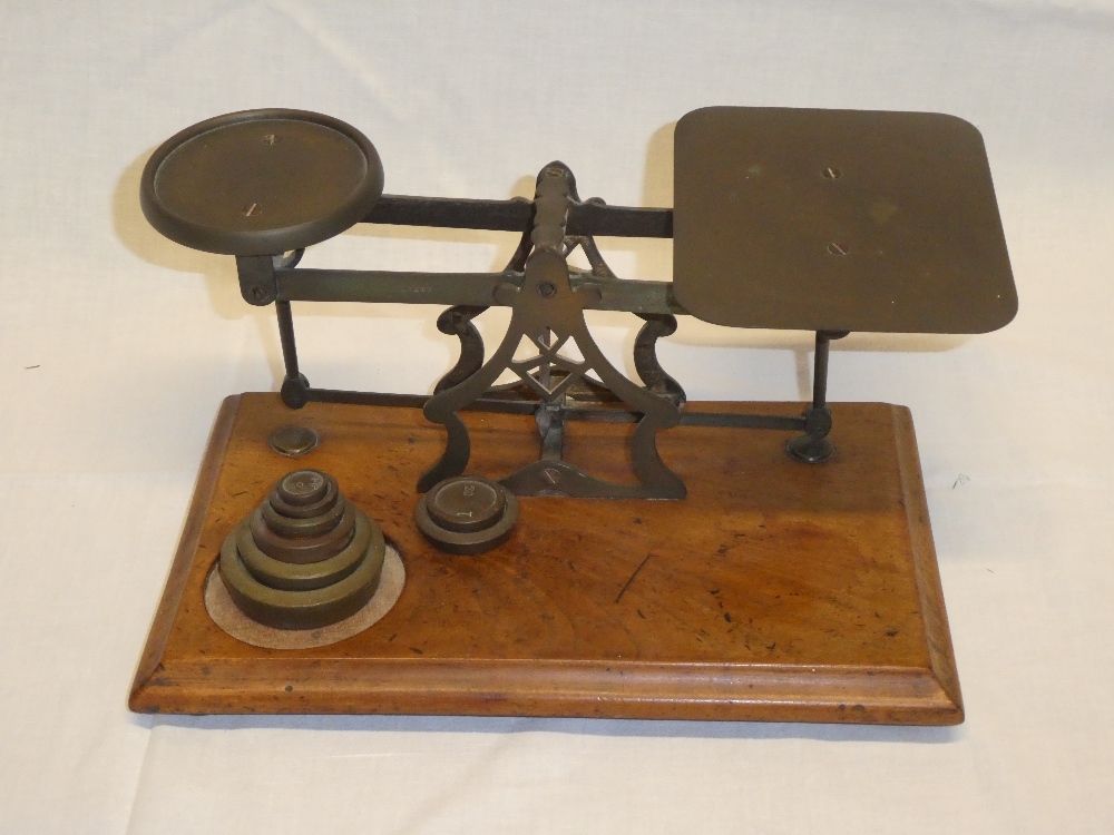 A large old brass postal-style scales by Avery on walnut rectangular base together with brass
