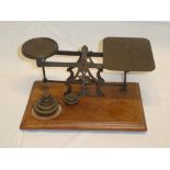 A large old brass postal-style scales by Avery on walnut rectangular base together with brass