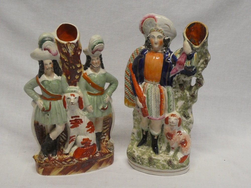Two Victorian Staffordshire pottery spill vase figures depicting Highlanders with dogs