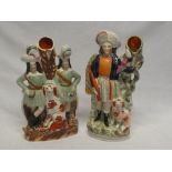 Two Victorian Staffordshire pottery spill vase figures depicting Highlanders with dogs