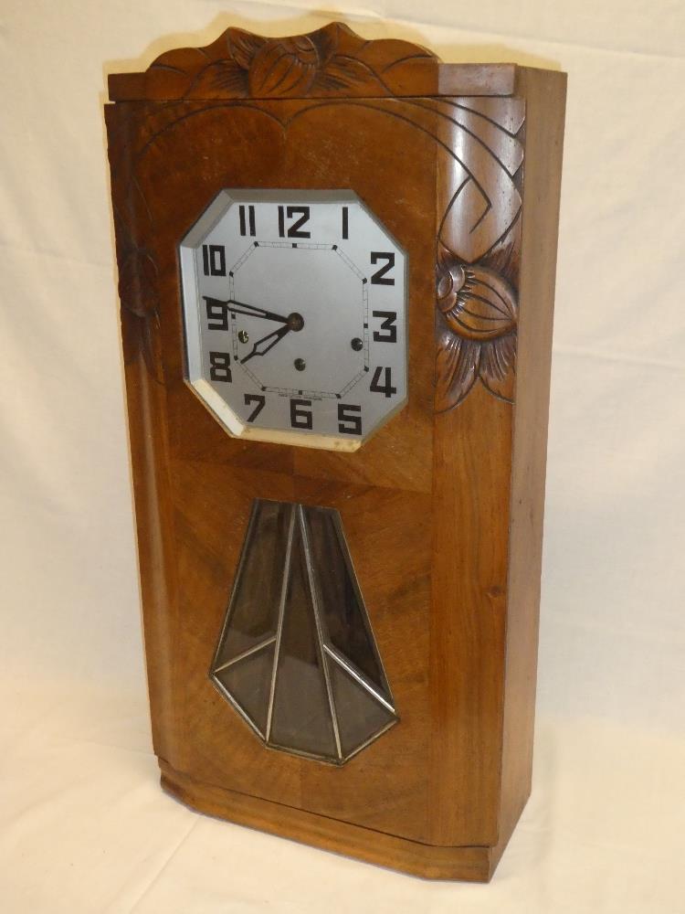 A 1930's French Art Deco-style wall clock with silvered octagonal dial in walnut angular case